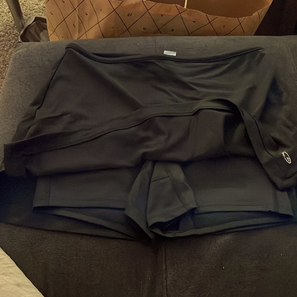 Black Tennis skirt with attached shorts and ball pocket in back with zipper. S